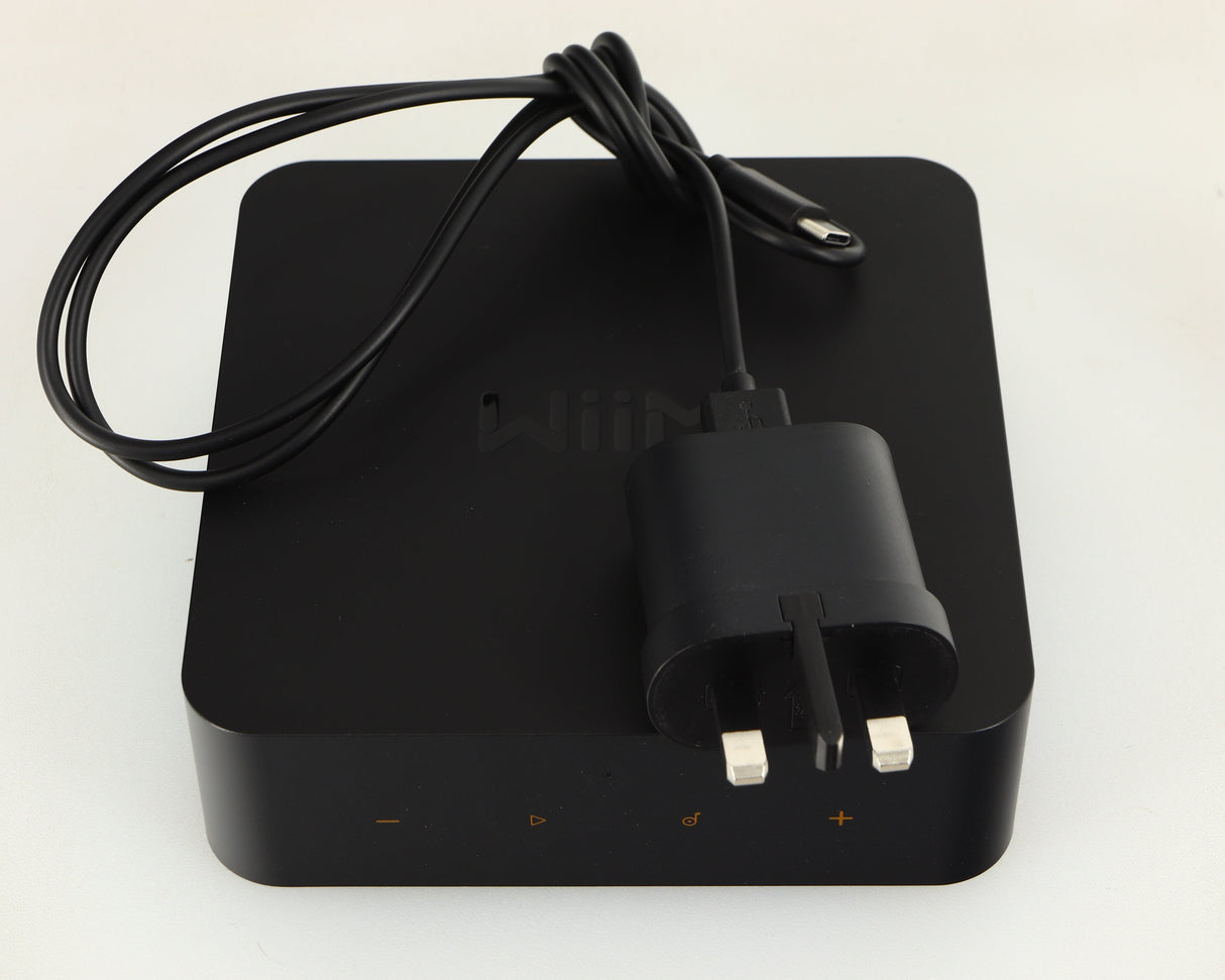 Top of a used WiiM Pro Streamer showing USB Cable