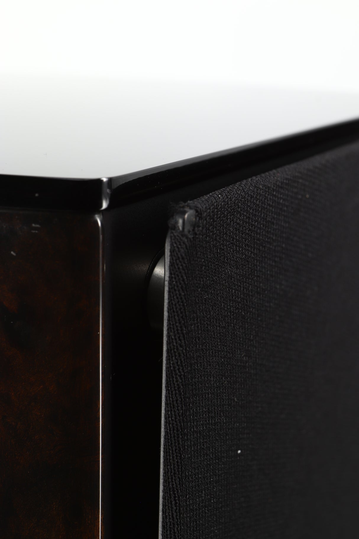 Close up of a used Wilson Benesch Vertex Standmount Speakers W/ Stands in a gloss walnut finish showing a small hole in the grille