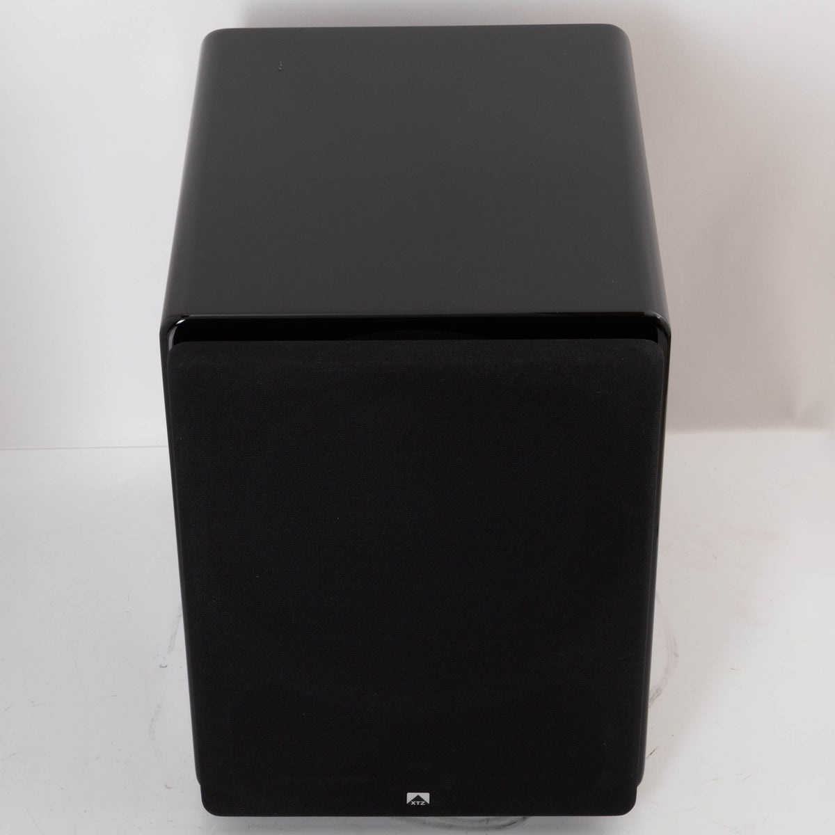 Top of a used XTZ SA-1 Subwoofer in a Gloss Black finish