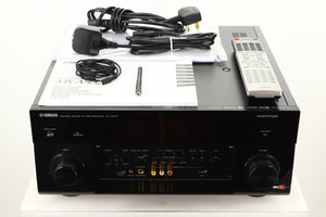 View of a used Yamaha CX-A5100 AV Pre Amplifier in Black finish with mains cables, manuals, remote, antenna, and 3.5mm cable