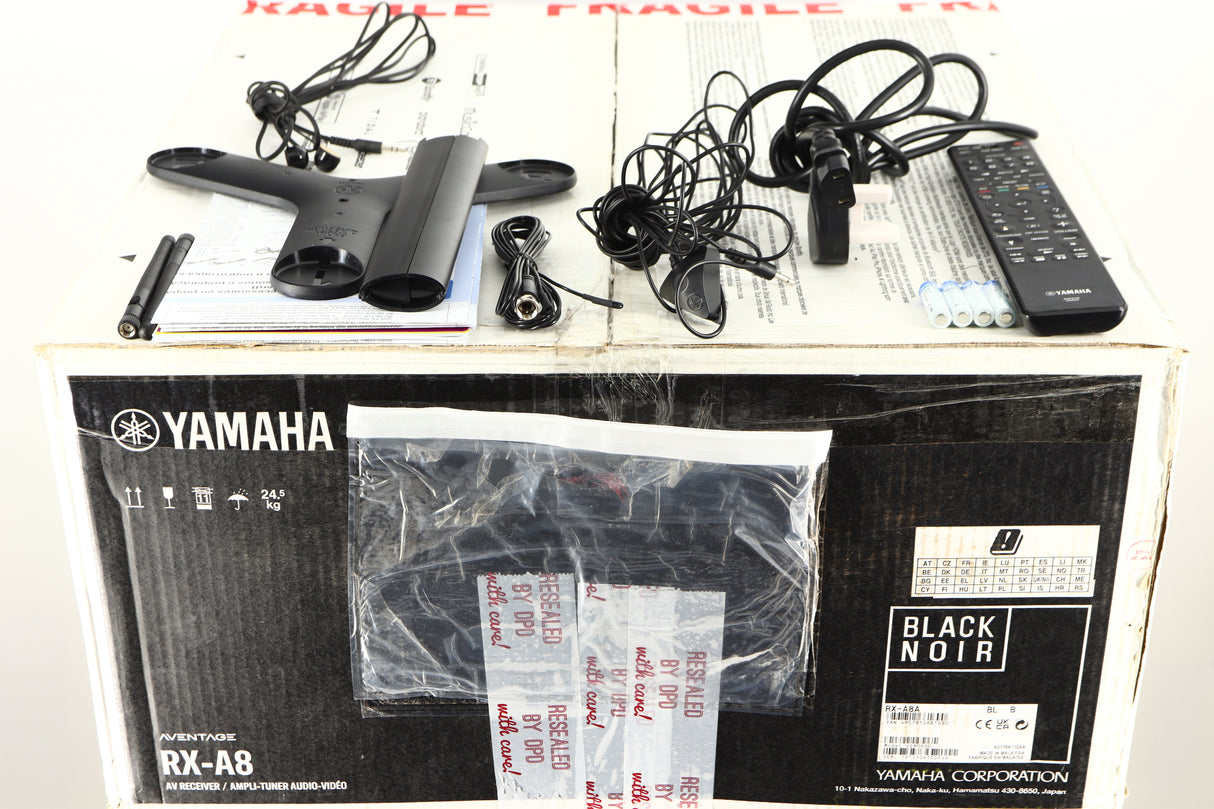 Box for a used Yamaha RX-A8A Aventage AV Receiver in a black finish showing Manual, Remote, Batteries, Mains Cable, Microphone, Microphone Stand, Bluetooth Antenna, Wi-Fi Antenna and Coaxial Cable
