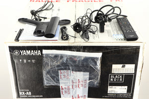 Box for a used Yamaha RX-A8A Aventage AV Receiver in a black finish showing Manual, Remote, Batteries, Mains Cable, Microphone, Microphone Stand, Bluetooth Antenna, Wi-Fi Antenna and Coaxial Cable