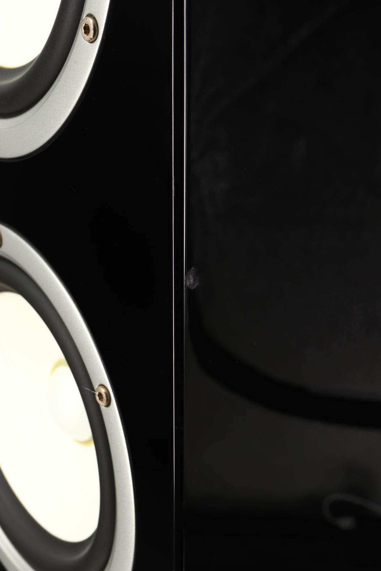 Close up of a used Yamaha Soavo 1 Floorstanding Speaker in a piano black finish showing chip on front right corner