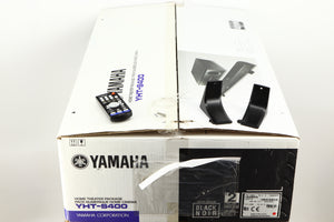 Box for a used Yamaha SR-300 Integrated Receiver in a black finish showing Remote, 2x Batteries, 2x Feet and 2x Screws