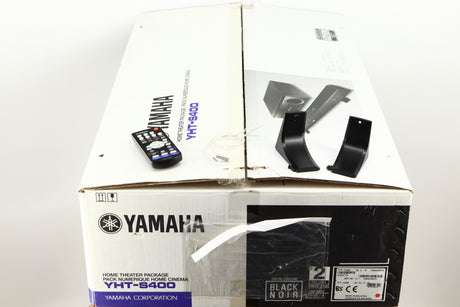 Box for a used Yamaha SR-300 Integrated Receiver in a black finish showing Remote, 2x Batteries, 2x Feet and 2x Screws